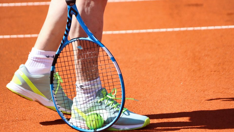 Close up image of tennis racket and ball